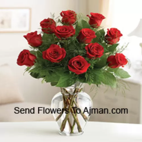 12 Red Roses With Some Ferns In A Glass Vase