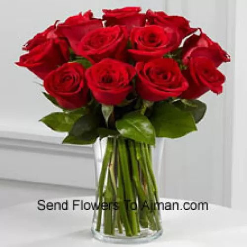 12 Red Roses With Some Ferns In A Vase